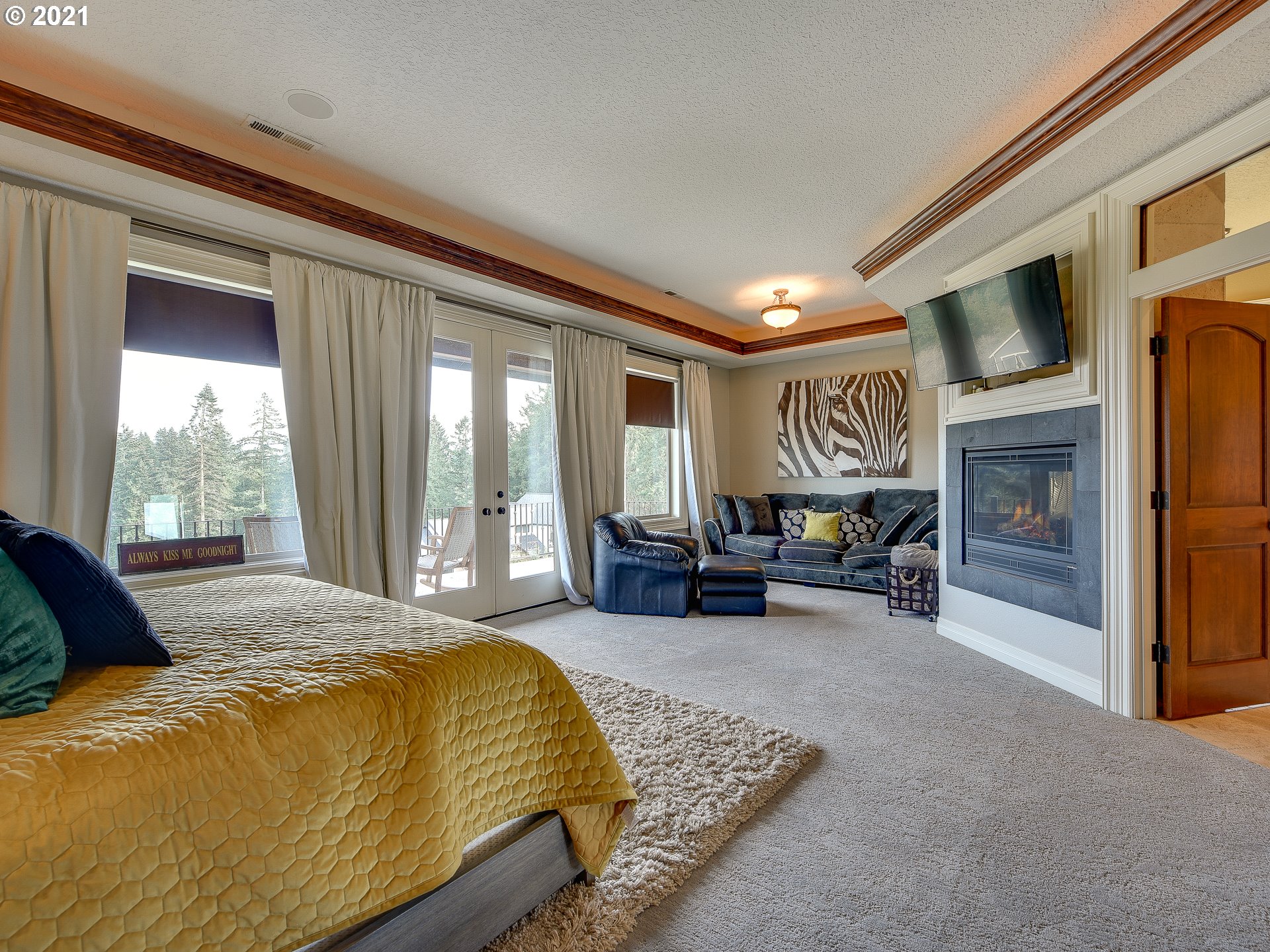 1711 South 8th Way Ridgefield, WA 98642 - Photo 14 of 28 a spacious bedroom with a bed and glass door