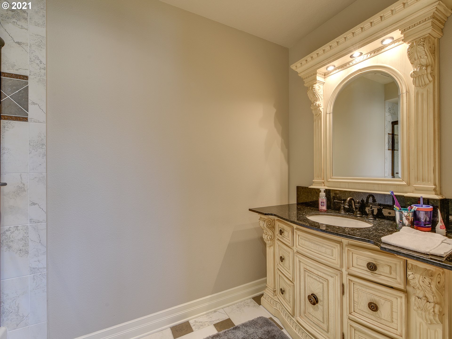 1711 South 8th Way Ridgefield, WA 98642 - Photo 21 of 28 a bathroom with a sink and a mirror