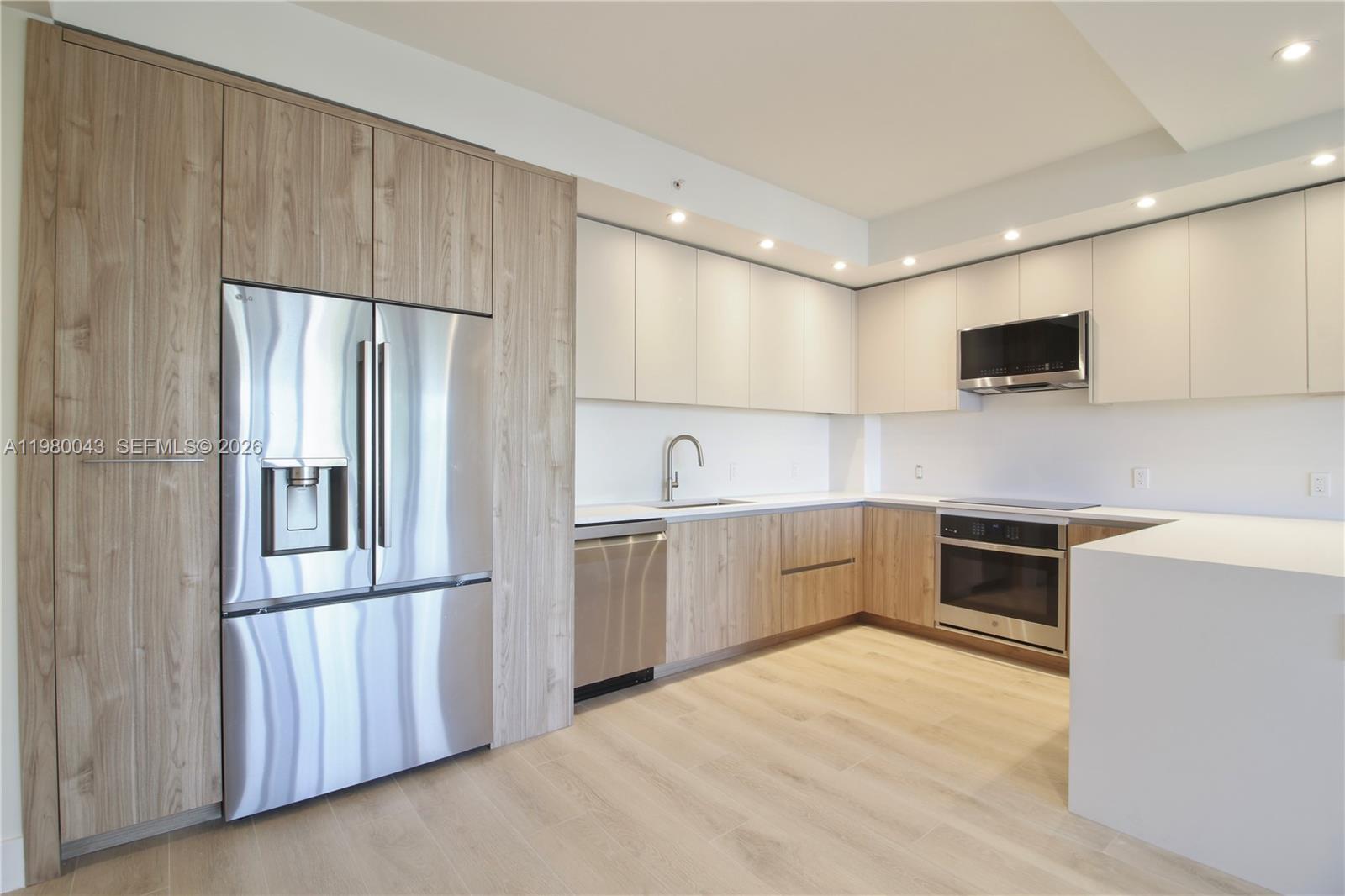 151 Crandon Boulevard, Unit 540 Key Biscayne, FL 33149 - Photo 14 of 40 a kitchen with granite countertop a refrigerator and a stove top oven