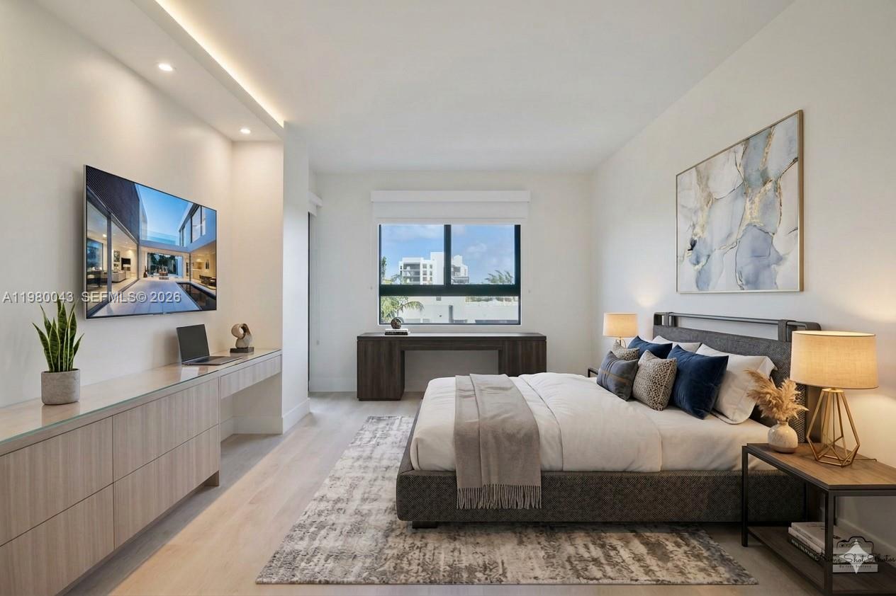 151 Crandon Boulevard, Unit 540 Key Biscayne, FL 33149 - Photo 2 of 40 a bedroom with a large bed and a chandelier