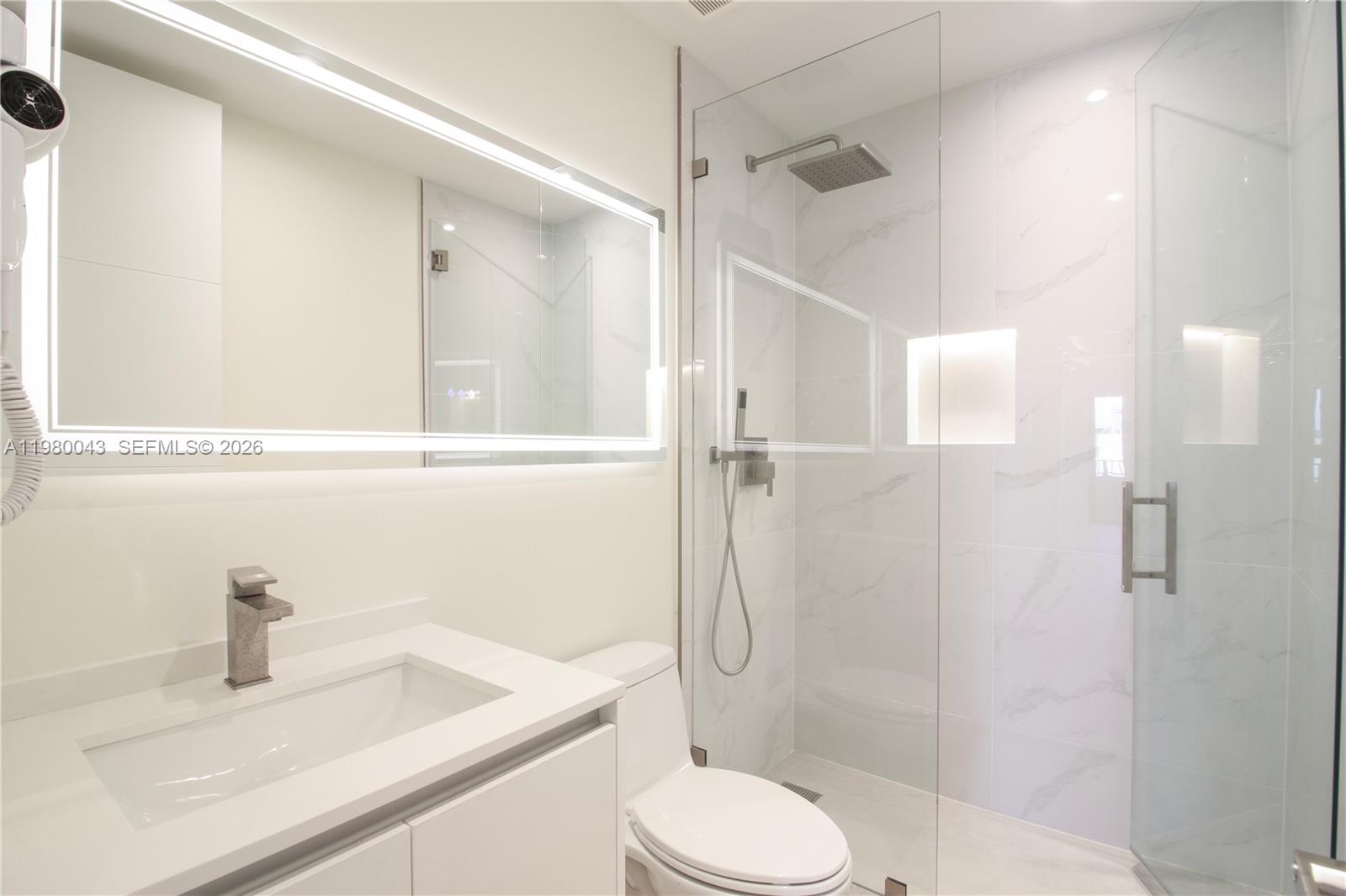 151 Crandon Boulevard, Unit 540 Key Biscayne, FL 33149 - Photo 28 of 40 a bathroom with a sink a toilet and shower