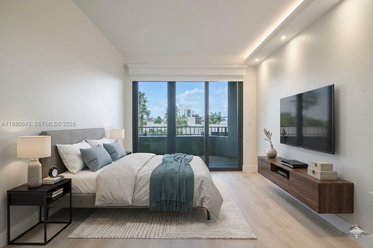 151 Crandon Boulevard, Unit 540 Key Biscayne, FL 33149 - Photo 3 of 40 a bedroom with a bed and large flat screen tv