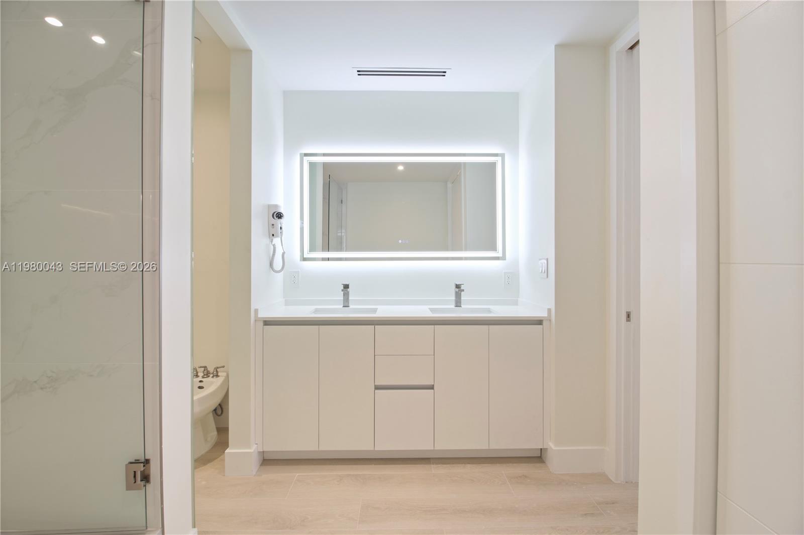 151 Crandon Boulevard, Unit 540 Key Biscayne, FL 33149 - Photo 38 of 40 a bathroom with a sink and a mirror