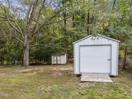a backyard of a house with a tree