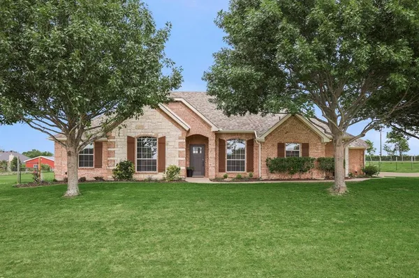 a front view of house with yard and green space