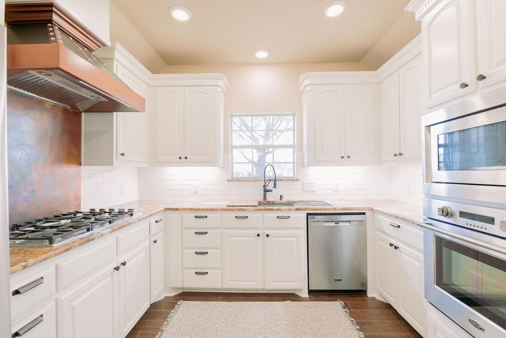 1377 Block Road Gunter, TX 75058 - Photo 14 of 37 a kitchen with granite countertop cabinets stainless steel appliances and a sink