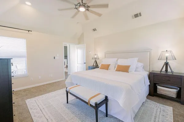 a bedroom with a bed and a chandelier
