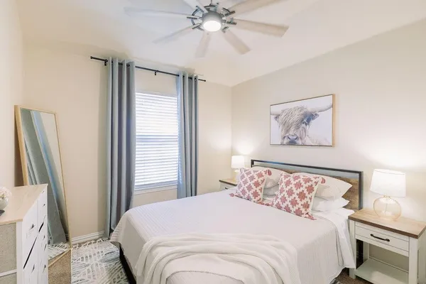 a bedroom with a large bed and a chandelier