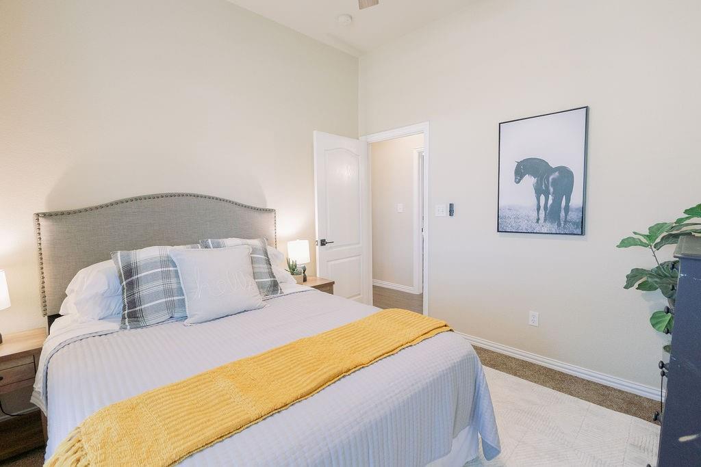1377 Block Road Gunter, TX 75058 - Photo 24 of 37 a bedroom with a large bed and a potted plant