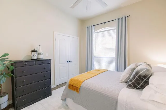 a bedroom with a bed and a dresser