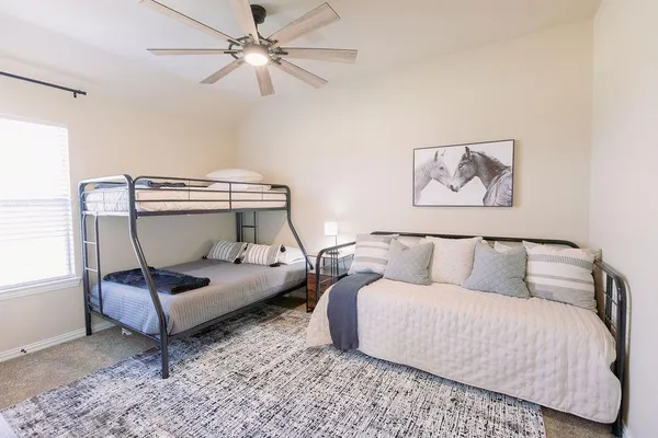 a living room with furniture and a ceiling fan