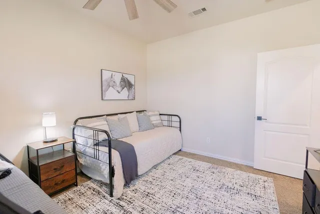 a bed room with a bed and a night stand