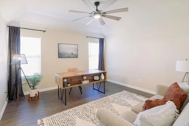 a reading room with furniture wooden floor and a window