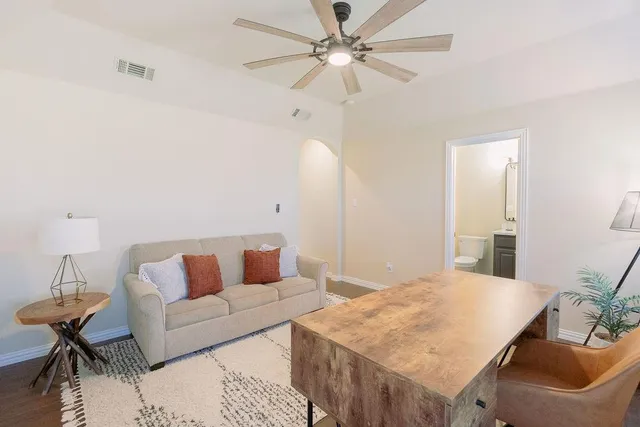 a living room with furniture and a chandelier