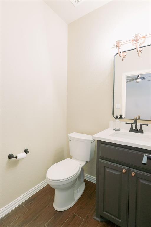 1377 Block Road Gunter, TX 75058 - Photo 30 of 37 a bathroom with a toilet a sink and mirror