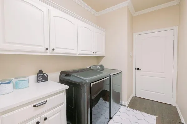 a utility room with sink dryer and washer
