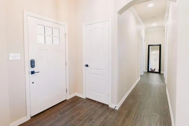 a view of a hallway with wooden floor