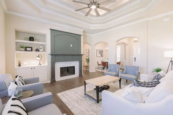 a living room with furniture fireplace and a table