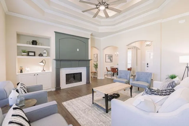 a living room with furniture fireplace and a table