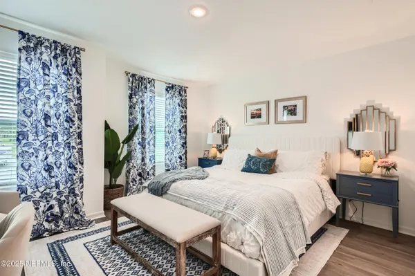 a bedroom with double bed and a potted plant