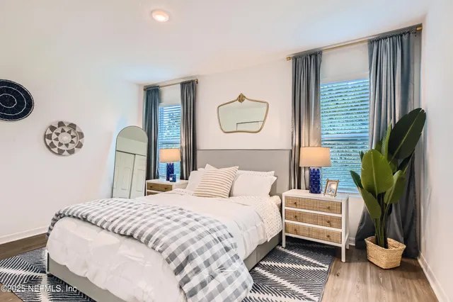 a bedroom with a bed a mirror and a window