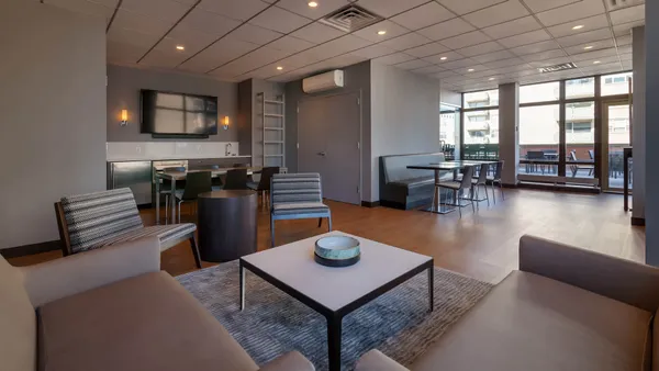 a living room with furniture a flat screen tv and a large window