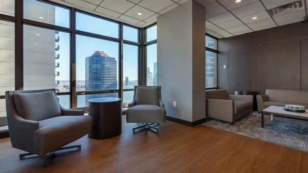 a living room with furniture and a floor to ceiling window