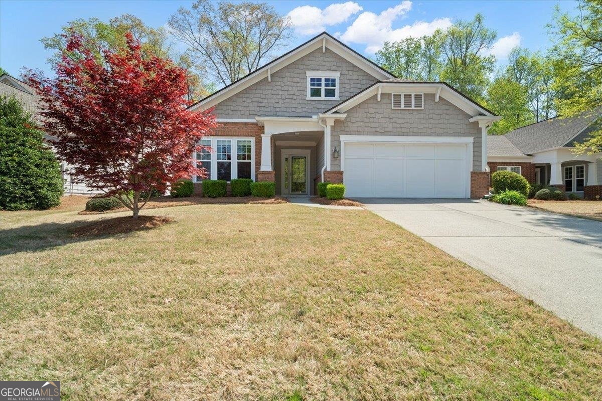 5125 Kings Common Way, Unit 5125 Cumming, GA 30040 - Photo 1 of 1 a front view of a house with a yard and garage