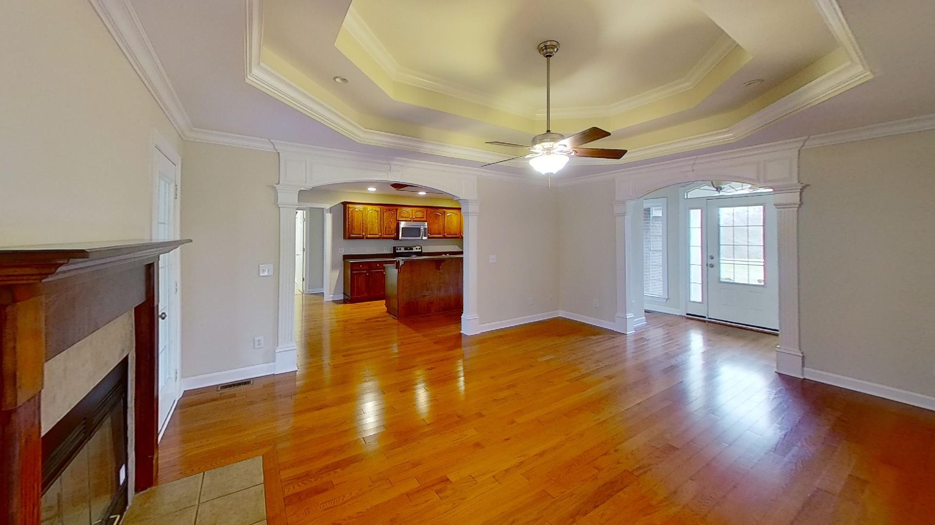 2136 Clara Mathis Road Spring Hill, TN 37174 - Photo 8 of 23 a view of a livingroom with a fireplace a chandelier and wooden floor