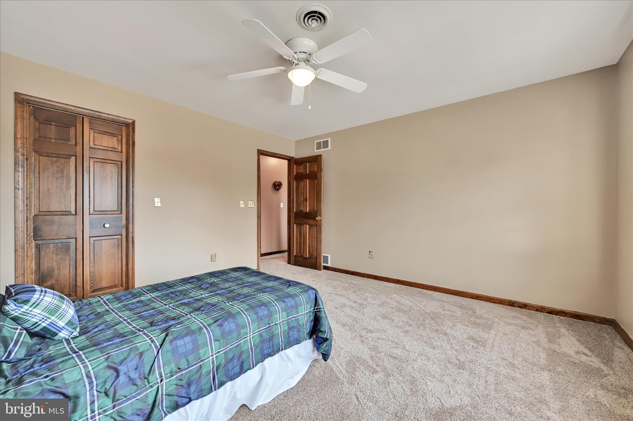 921 Acri Road Mechanicsburg, PA 17050 - Photo 20 of 46 a bedroom with a bed and a chandelier fan
