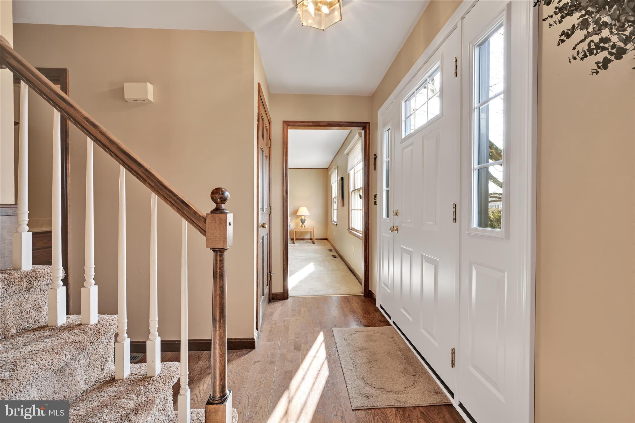 921 Acri Road Mechanicsburg, PA 17050 - Photo 3 of 46 a view of a hallway with wooden floor and staircase