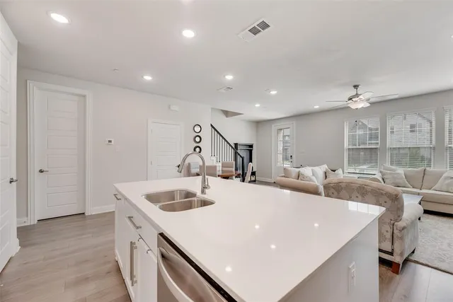 a large white kitchen with a large island