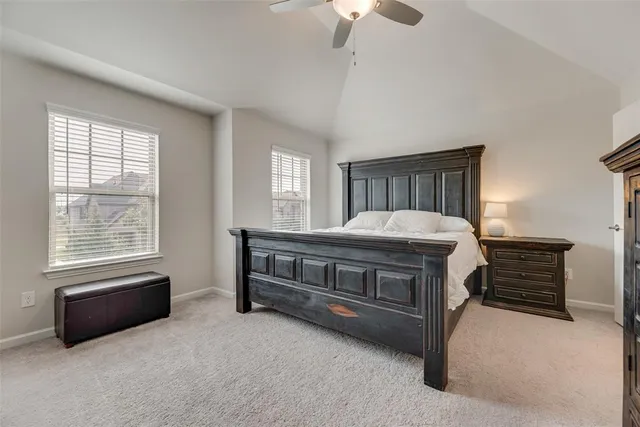 a spacious bedroom with a bed and a chandelier