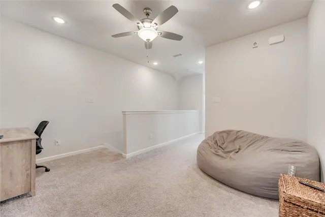 a living room with furniture and a ceiling fan