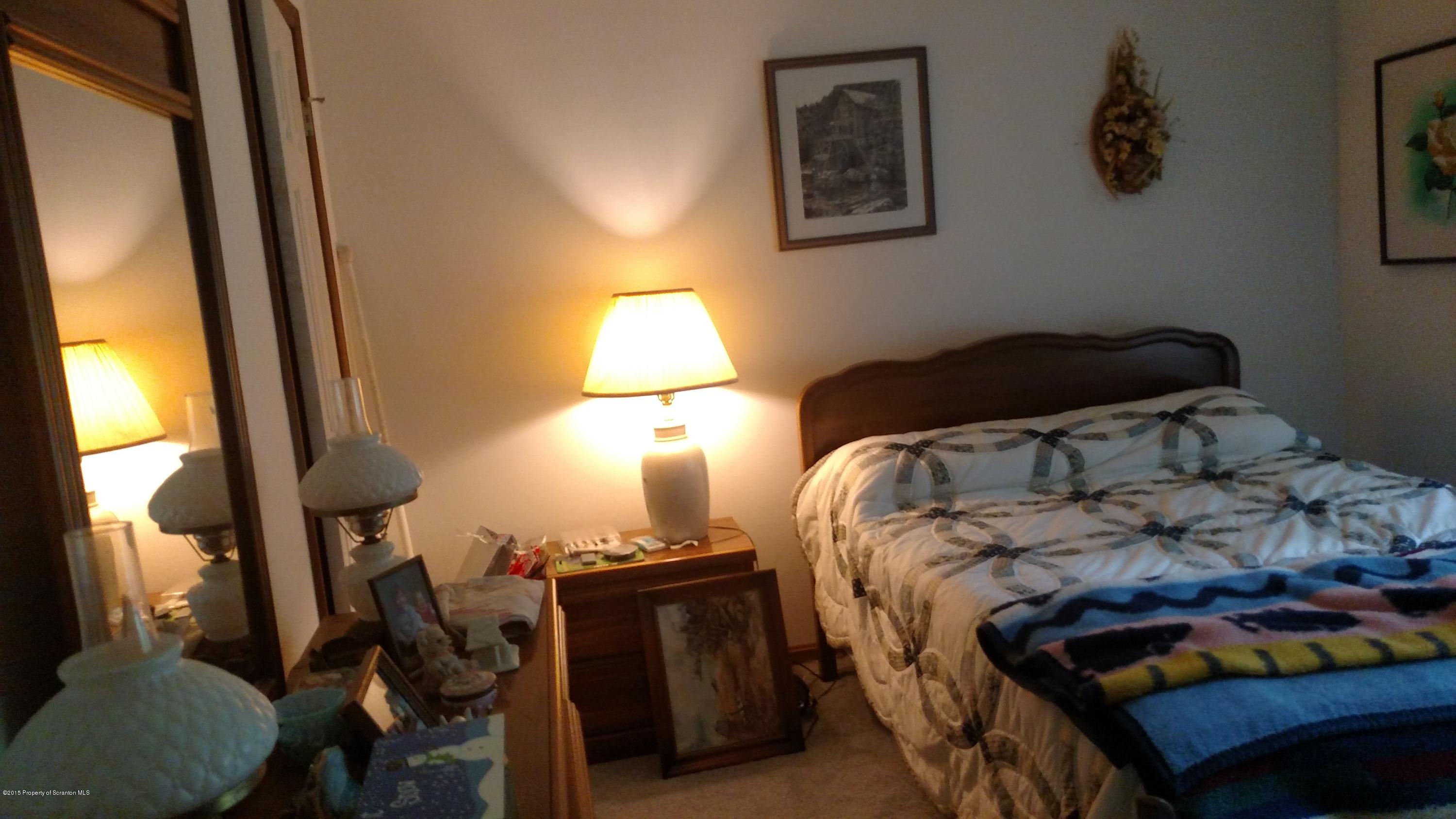 234 Hilltop Road Newfoundland, PA 18445 - Photo 11 of 21 a bedroom with a bed and a window