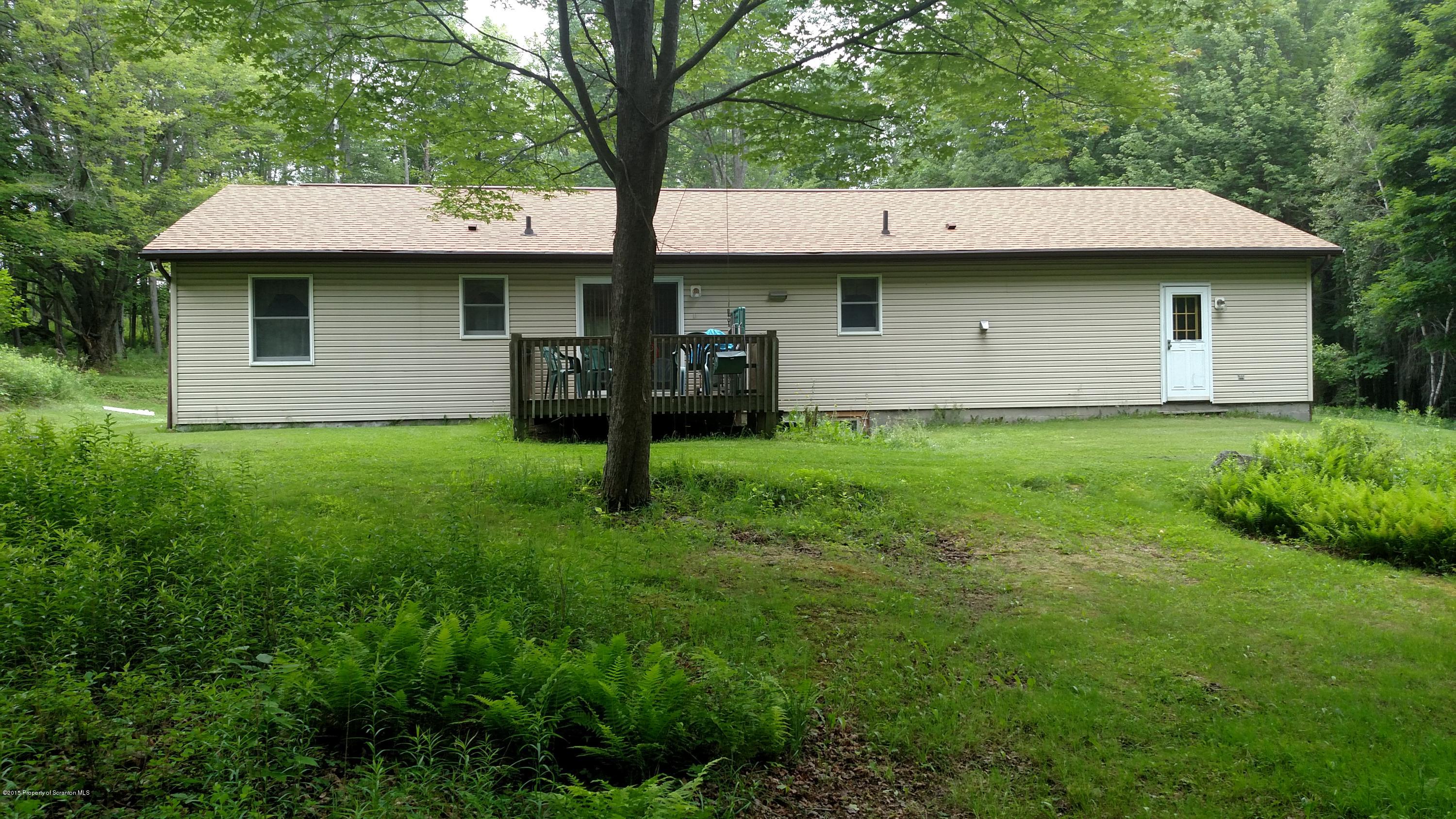 234 Hilltop Road Newfoundland, PA 18445 - Photo 3 of 21 a view of a house with a yard and tree