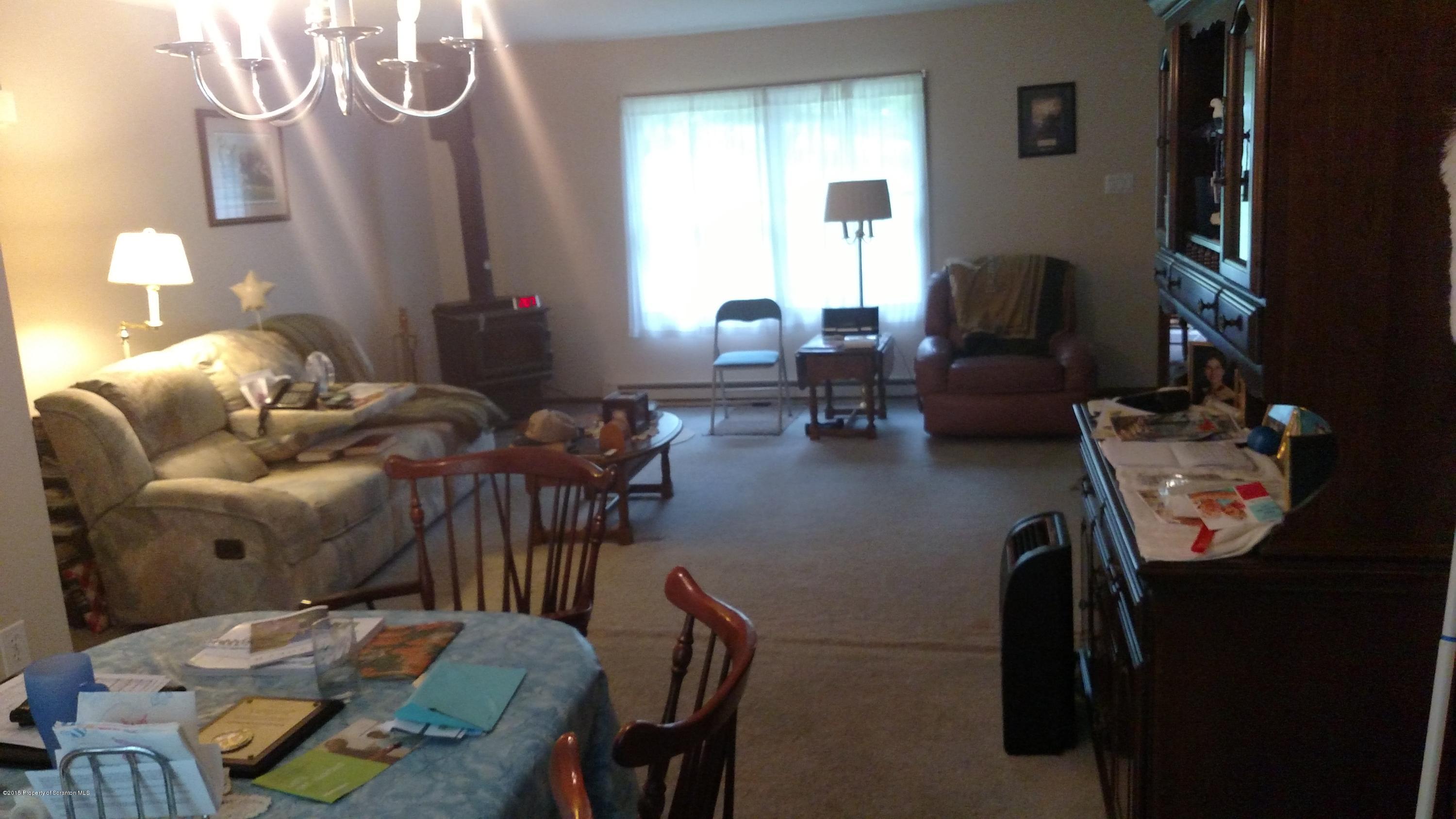 234 Hilltop Road Newfoundland, PA 18445 - Photo 7 of 21 a living room with furniture and a chandelier