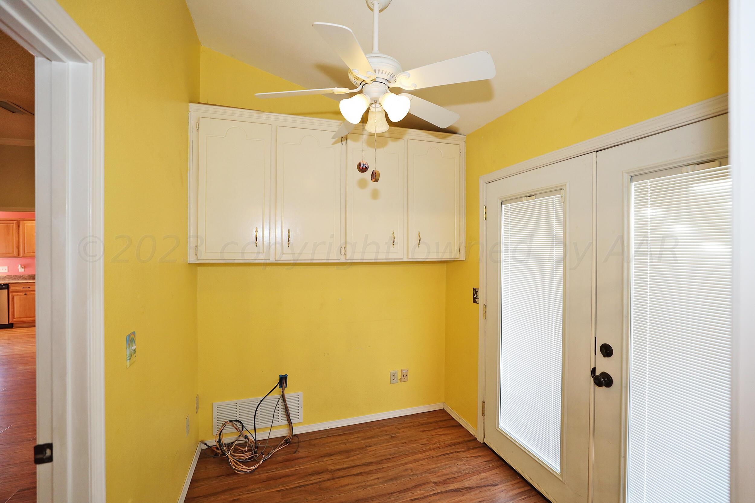 4207 Rincon Avenue Amarillo, TX 79110 - Photo 11 of 26 a view of a room with wooden floor and ceiling fan