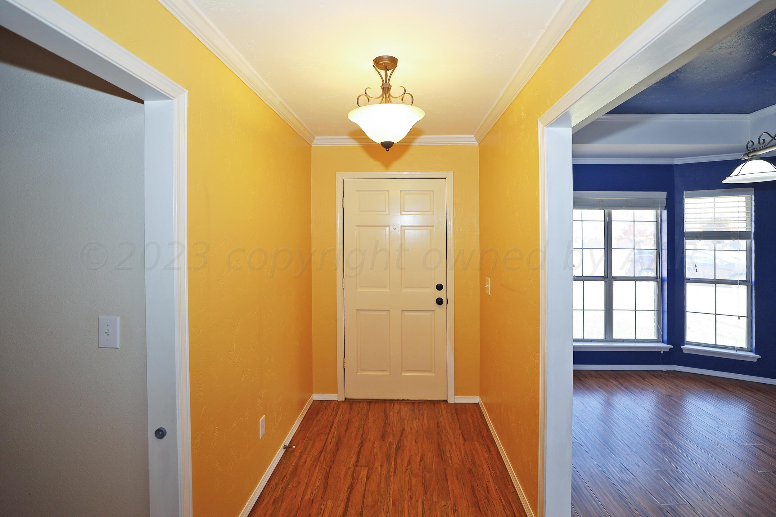 4207 Rincon Avenue Amarillo, TX 79110 - Photo 2 of 26 a view of a room with wooden floor and window