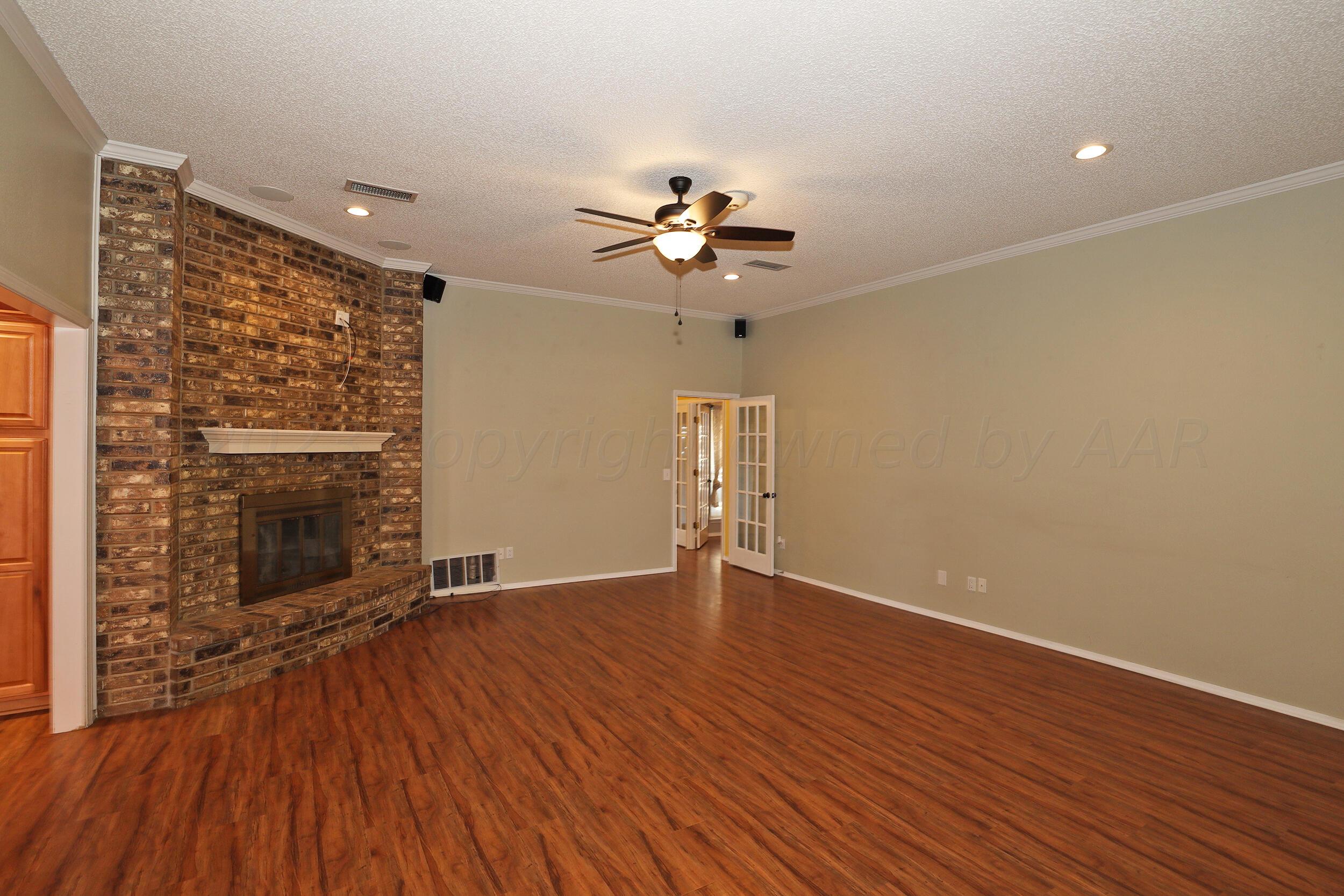 4207 Rincon Avenue Amarillo, TX 79110 - Photo 3 of 26 wooden floor in an empty room with a window