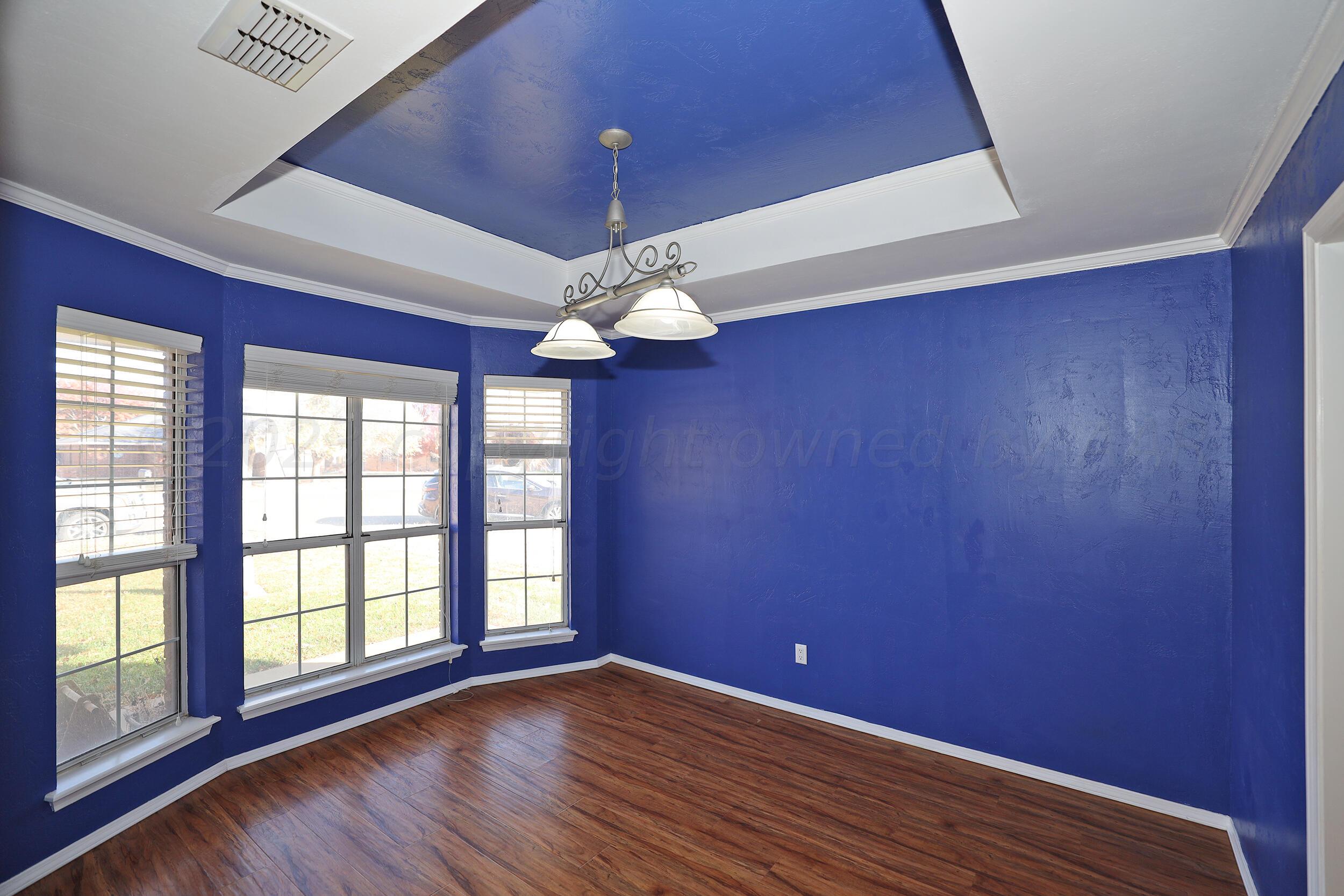 4207 Rincon Avenue Amarillo, TX 79110 - Photo 10 of 26 a view of empty room with window and wooden floor