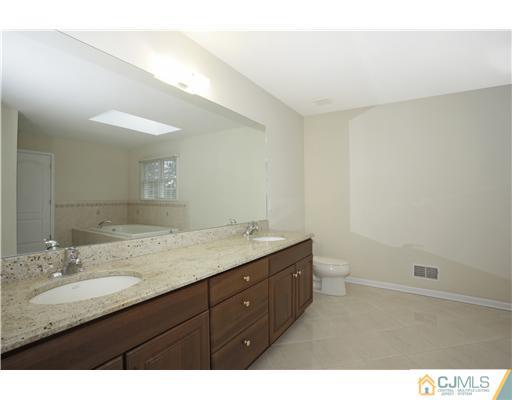 11 Homestead Road Edison, NJ 08820 - Photo 22 of 25 a bathroom with a granite countertop sink mirror and double