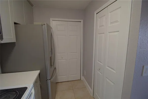 an empty room with wooden floor and window