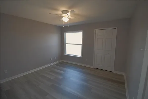a bathroom with a toilet sink vanity and mirror