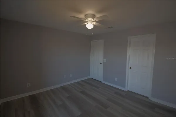 a bathroom with a tub sink vanity and mirror