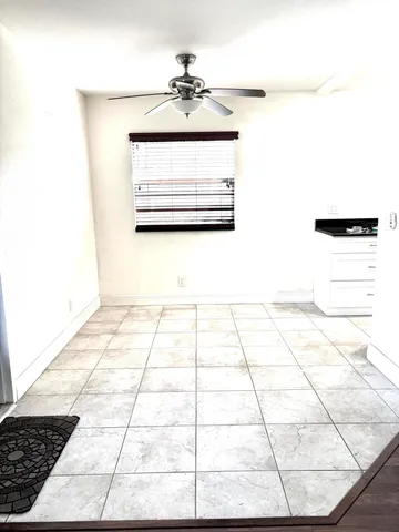 a kitchen with a refrigerator and a stove top oven