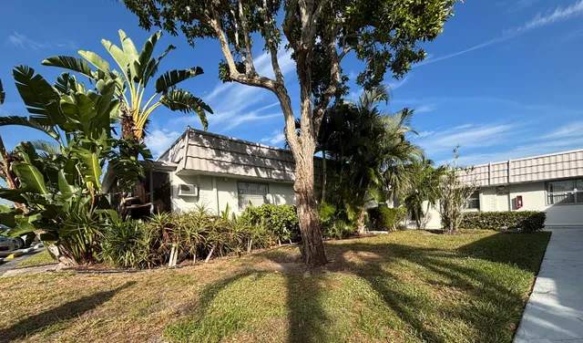 a view of swimming pool with outdoor seating and covered with trees