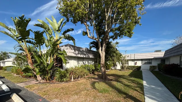 a view of a house with potted plants