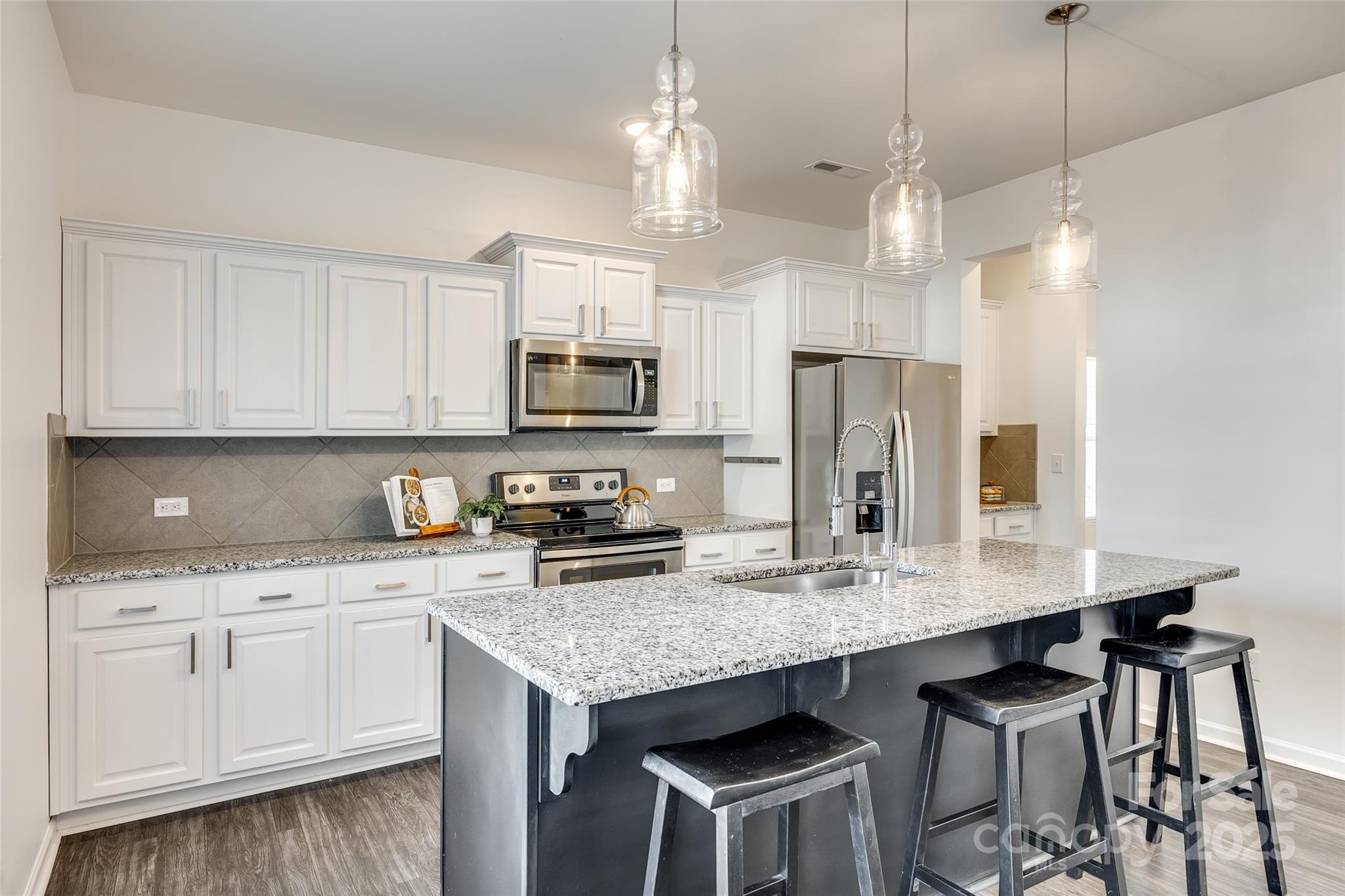 634 Gants Road York, SC 29745 - Photo 12 of 42 a kitchen with kitchen island granite countertop a sink cabinets and refrigerator