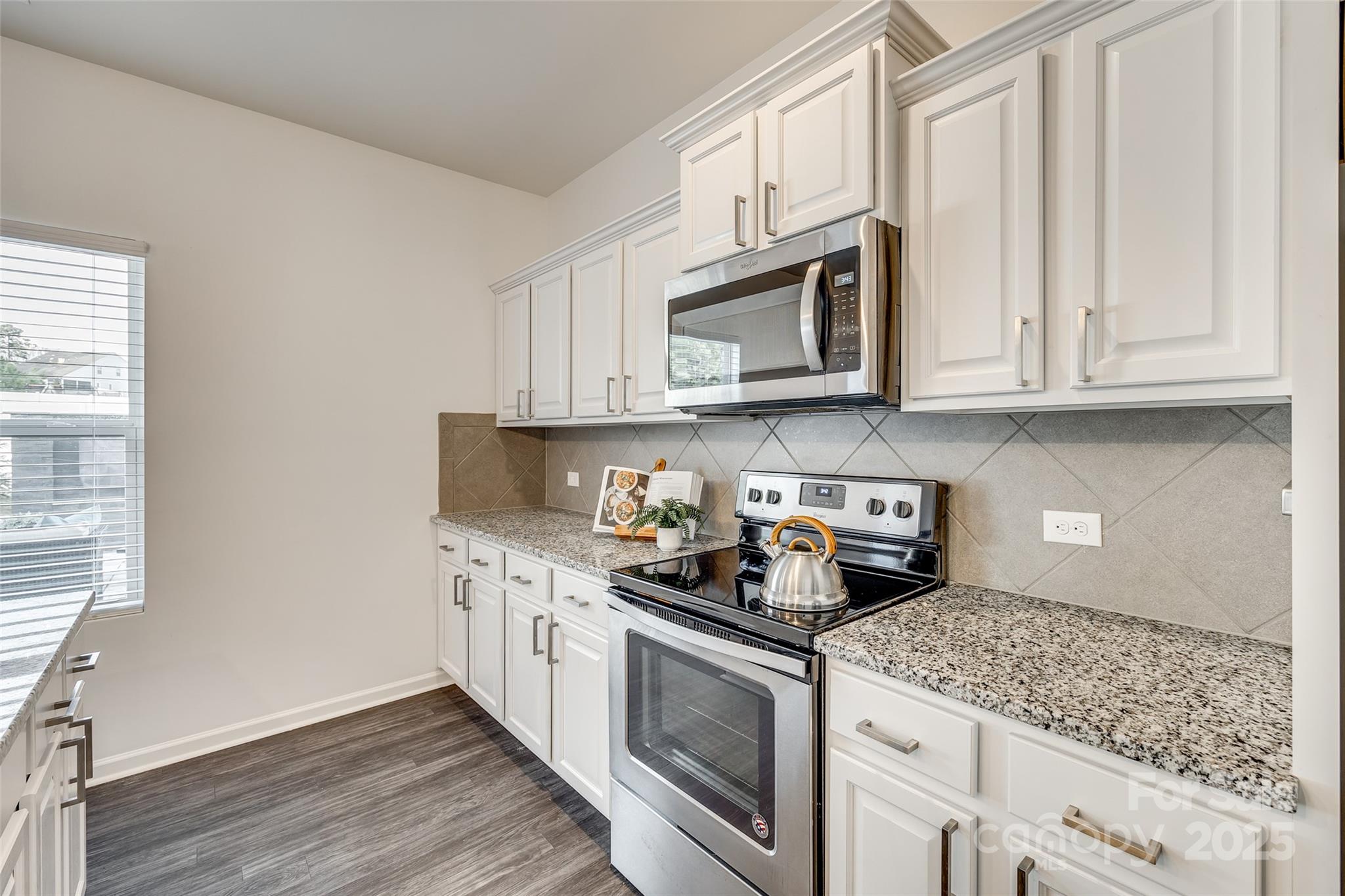 634 Gants Road York, SC 29745 - Photo 14 of 42 a kitchen with stainless steel appliances granite countertop white cabinets granite counter tops and a wooden floors